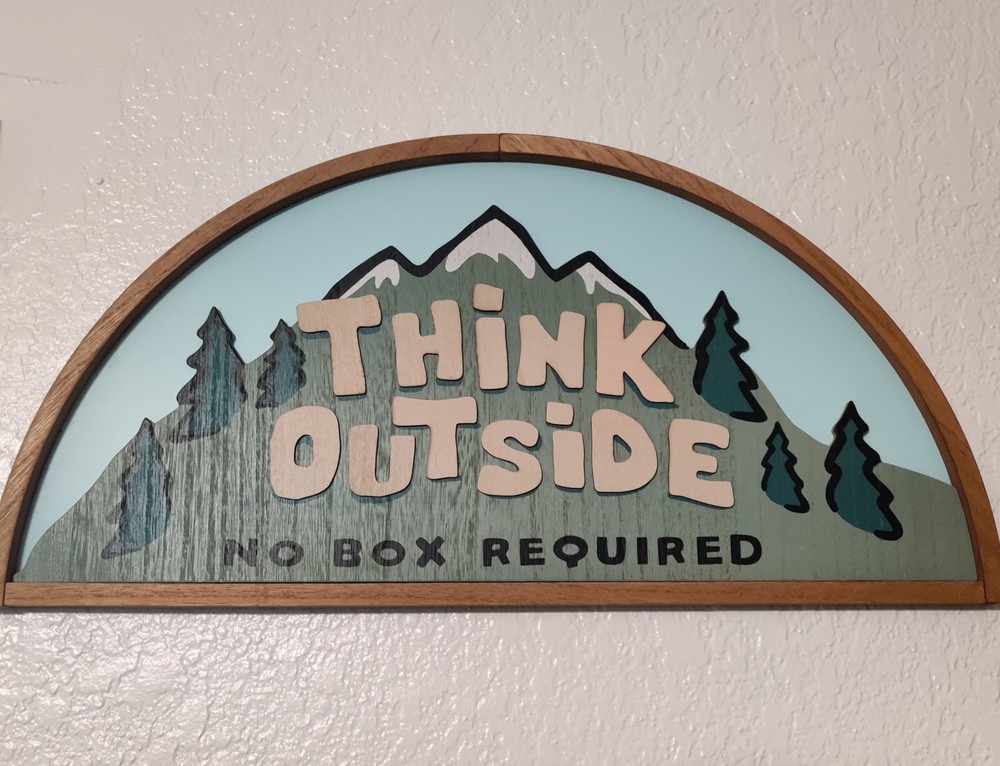 'Think Outside -- No box required', and a drawing of a mountain with snow and trees