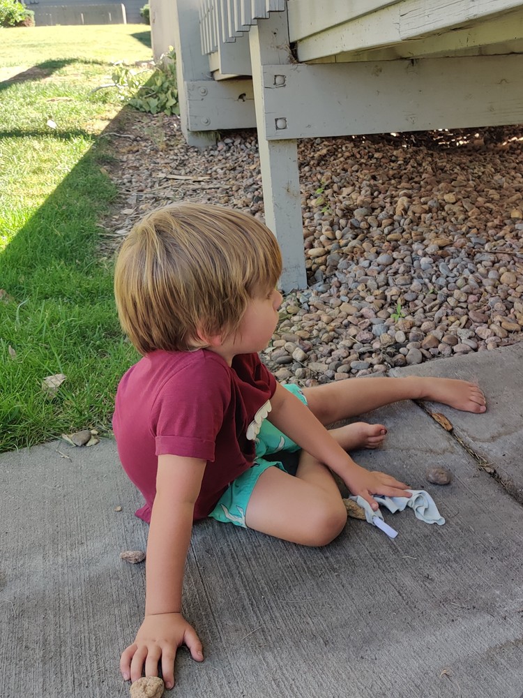 Damon playing with pebbles.